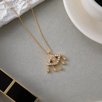 Uworld moda clásica 18K Color oro plateado acero inoxidable circón blanco ojo del diablo borla colgante collar joyería de mujer Pa