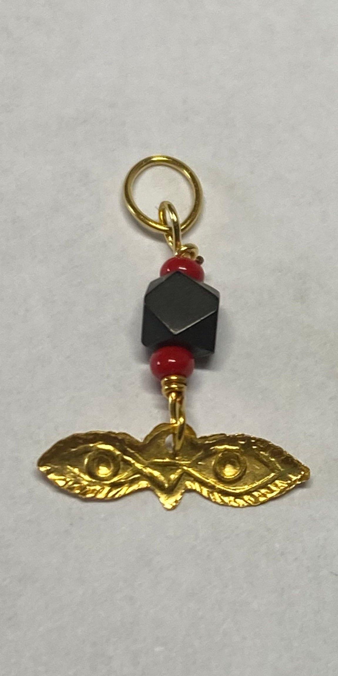 Charm de ojos pequeños "Santa Lucía" de oro amarillo de 10 quilates con azabache auténtico y coral